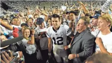  ?? GENE SWEENEY JR., GETTY IMAGES ?? BYU fans surround Tanner Mangum (12) on Saturday.