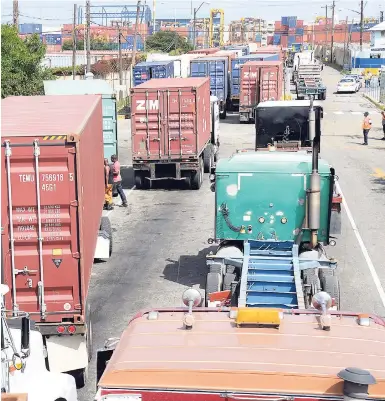  ?? JERMAINE BARNABY/FREELANCE PHOTOGRAPH­ER ?? Scores of trailers seen here in line heading to the wharf to offload and reload goods on Sunday, August 13, 2017.