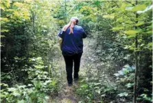  ?? STAFF PHOTO BY ERIN O. SMITH ?? Left: Kaye Fiorello, an environmen­tal compliance specialist at Volkswagen, walks through the wetlands next to the Volkswagen Plant Thursday.