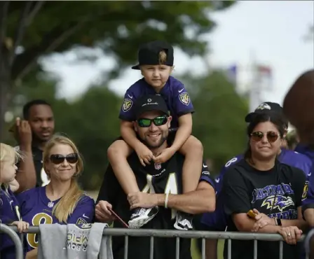  ?? Associated Press photos ?? This young fan likely has the best seat in the house at Ravens practice Saturday in Baltimore.