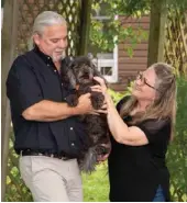  ??  ?? Tom and Jan take a short stroll with their Goldendood­le, Jaxie, before tending to the perennial gardens, rock gardens and limestone pathways that surround their home.