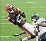  ?? Kirk Irwin / Associated Press ?? Cleveland Browns cornerback Denzel Ward (21) intercepts a pass intended for Philadelph­ia Eagles wide receiver Alshon Jeffery (17) during a game in November.