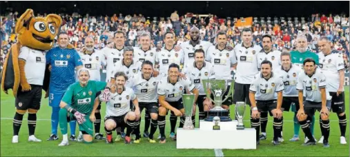  ?? ?? Los miembros de la plantilla del Valencia 2003-04 y 2004-05 posan con los trofeos.