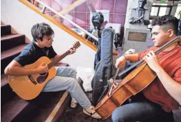  ?? PROVIDED BY TARA HOWARD ?? Jordan Kennedy of the band Momma’s Boys, left, and cellist Josh Witte rehearse ahead of the 26th annual McCallum Theatre Open Call Talent Project.