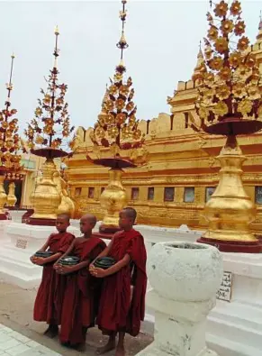  ??  ?? Monks asking for alms at the foot of Shwezigon Paya pagoda. Males in Myanmar go for monk training at least twice in their life. – Filepic