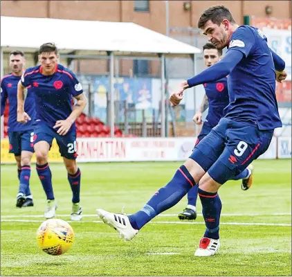  ??  ?? CASHING IN: Lafferty strokes home the penalty for Hearts to seal Craig Levein’s first win of his second spell in charge