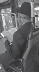  ?? PHOTO BY THOMAS FROESE, ?? The reading of Hebrew texts, like this Orthodox Jew is reading while on a bus in Tel Aviv, is a common sight in Israel because the ancient narrative of the Jewish people remains central to their modern cultural identity in the reborn Jewish state.