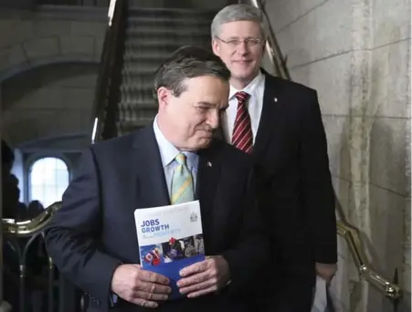  ?? PATRICK DOYLE/REUTERS ?? Finance Minister Jim Flaherty and Prime Minister Stephen Harper walk to deliver the budget in the House of Commons.