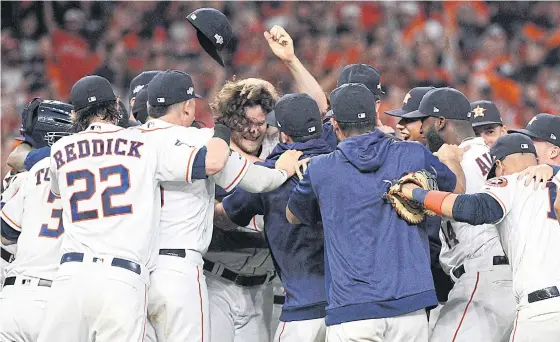  ??  ?? Houston’s Gerrit Cole, centre, and teammates celebrate their win against Tampa Bay in Game Five of the American League Division Series.