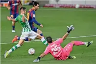  ?? AFP ?? KEEN TUSSLE: Real Betis’ Marc Bartra (left) vies for the ball with Lionel Messi. —