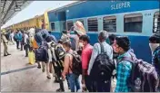  ??  ?? Migrants from Bengaluru walk in a queue after reaching Danapur railway station via a special train, in Patna, on Tuesday