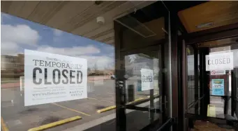  ?? GETTY IMAGES ?? RARE BREAK: Signs at a Colorado Waffle House say the restaurant — usually open 24 hours a day, seven days a week — is closed.