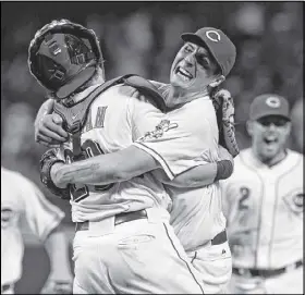  ?? AL BEHRMAN / AP ?? Reds starting pitcher Homer Bailey hugs catcher Ryan Hanigan after Bailey completed his no-hitter against the Giants on Tuesday night. Bailey also threw the majors’ last no-hitter, last season.