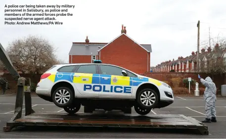  ?? Photo: Andrew Matthews/PA Wire ?? A police car being taken away by military personnel in Salisbury, as police and members of the armed forces probe the suspected nerve agent attack.
