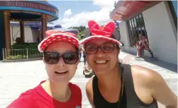  ??  ?? KIDDING AROUND: Jade Otto and colleague Riana Howa touch down in Hong Kong Disneyland.