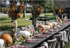  ?? Melissa Phillip / Houston Chronicle ?? Lucas-Eilers Design Associates designed an outdoor tablescape for 28 using pumpkins, gourds, antlers and tall, skinny vases holding bouquets of fall flowers. Tableware courtesy of Kuhl-Linscomb.