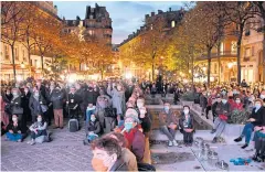  ?? AFP ?? People gather at the Place de la Sorbonne in Paris on Wednesday to watch a live broadcast of a national homage to French teacher Samuel Paty.