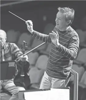  ?? ?? Music Director Alexander Mickelthwa­te, shown conducting the Oklahoma City Philharmon­ic in a 2019 rehearsal, will collaborat­e on “Concerto,” tracing the creation of Tchaikovsk­y’s Violin Concerto in D major.
DOUG HOKE/THE OKLAHOMAN FILE