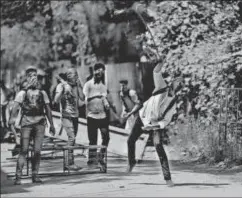  ?? AP ?? A Kashmiri student uses his necktie as a sling to throw stones at policemen as they clash in Srinagar, May 15