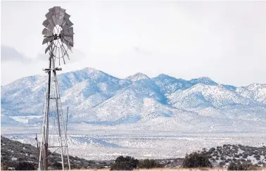  ?? EDDIE MOORE/JOURNAL ?? The snowy Ortiz Mountains as seen from a windmill near Galisteo on Monday. The area received around 1 inch of snow Sunday night and Monday morning.