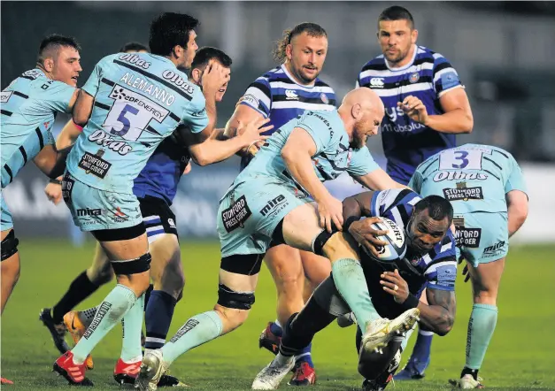  ?? PICTURE: Harry Trump/getty Images ?? Semesa Rokoduguni is tackled by former Bath player Matt Garvey during the Blue, Black and White’s comeback victory over Gloucester on Tuesday to go second in the Gallagher Premiershi­p