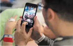  ??  ?? Brian Chong takes a photo of wife Kate and their new baby girl Adelynn Susandrea Chong