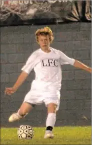  ?? For Montgomery Media / SUSAN KEEN ?? Faith Christian’s Zach Hambleton kicks the ball during Wednesday night’s playoff action against Church Farm.