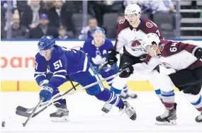  ??  ?? Toronto defenceman Jake Gardiner battles for control of the puck with Colorado Avalanche right winger Nail Yakupov.