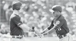  ?? JASON MILLER/GETTY ?? Max Kepler, left, slaps hands with Jorge Polanco after Polanco’s two-run homer.