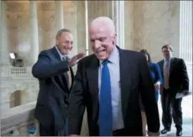  ?? J. SCOTT APPLEWHITE — THE ASSOCIATED PRESS FILE ?? Sen. John McCain, R- Ariz., laughs as he and Sen. Chuck Schumer, D- N. Y., left, cross paths in the Russell Senate Office Building, on Capitol Hill in 2013.