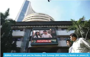  ?? ?? MUMBAI: Pedestrian­s walk past the Bombay Stock Exchange (BSE) building in Mumbai on January 23, 2024. India’s stock market has edged out Hong Kong to become the world’s fourth-largest, a milestone that underscore­s growing global investor optimism about New Delhi’s economic prospects.—AFP