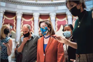  ?? J. Scott Applewhite / Associated Press ?? House Speaker Nancy Pelosi, D-Calif., walks to the chamber for a vote, joined at left by actor Woody Harrelson, at the Capitol in Washington on Wednesday.