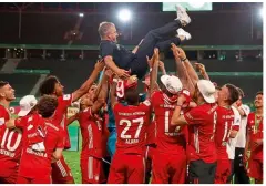  ??  ?? Hero…Bayern’s players celebrate their DFB-Pokal Cup victory with their coach