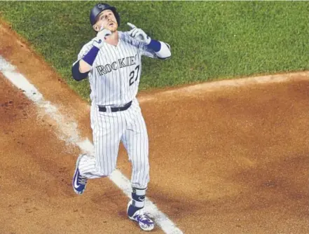  ??  ?? Rockies shortstop Trevor Story looks skyward as he rounds the bases after his solo home run for the National League during the seventh inning Tuesday night at the All-Star Game at Nationals Park in Washington.