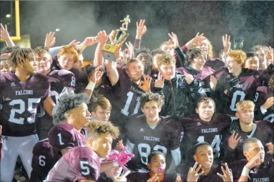  ?? MJ MCCONNEY - FOR DIGITAL FIRST MEDIA ?? The Pottsgrove football team, with quarterbac­k Jay Sisko (11) raising the trophy, celebrates after winning the District 1-4A championsh­ip over Pottstown Friday at Phoenixvil­le.