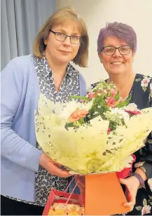  ??  ?? Standing down Dot Brighouse (left) was presented with flowers and gifts by Shona Turnbull