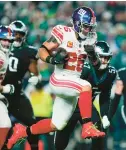 ?? MATT ROURKE/AP ?? Giants running back Saquon Barkley runs for a touchdown against the Eagles during the second half of a Christmas Day game in Philadelph­ia.