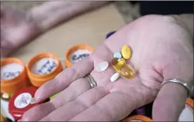  ?? PHELAN M. EBENHACK — THE ASSOCIATED PRESS ?? Retiree Donna Weiner shows some of the daily prescripti­on medication­s that she needs and pays over $6,000 a year through a Medicare prescripti­on drug plan at her home on Tuesday in Longwood, Fla.