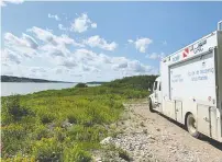  ??  ?? Manitoba RCMP’s Underwater Recovery Team works at the Nelson
River after a damaged aluminum boat was found on the shore.