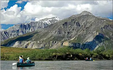  ?? PHOTOS BY MARLENA SLOSS / FOR THE WASHINGTON POST ?? My family canoes the Noatak River in June while taking in the sweeping peak views in Gates of the Arctic National Park.