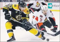  ?? AP PHOTO ?? Boston Bruins’ Brad Marchand (63) and Ottawa Senators’ Cody Ceci (5) battle for the puck during the second period in Game 6 of a first-round NHL Stanley Cup playoff series Sunday in Boston.