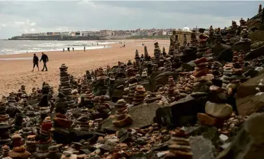  ??  ?? LEFT: Stone stacks built by members of the public on their daily walks during the COVID-19 pandemic are pictured on the beach in Whitley Bay, North Tyneside, on 30 April.