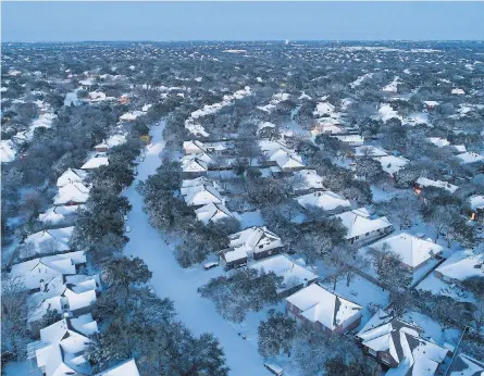  ?? JAY JANNER/ USA TODAY NETWORK ?? A rare snow, 6 inches deep, blanketed Austin, Texas, on Monday, when more than 70% of the U. S. was snow- covered. Utilities in Texas initiated rolling power outages and urged people to reduce electricit­y use.