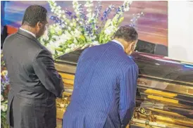  ?? KEREM YUCEL/AFP VIA GETTY IMAGES ?? The Rev. Jesse Jackson (right) and his son Jonathan Jackson pay respects to George Floyd during a memorial service Thursday in Minneapoli­s.
