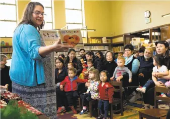  ?? Santiago Mejia / The Chronicle ?? Children’s librarian Meredith Steiner reads “Besos for Baby: A Little Book of Kisses” at the S.F. Public Library’s West Portal Branch as part of the We Love Diverse Books program.