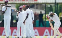  ?? AFP file ?? West Indies captain Jason Holder (left) signals to the third umpire for a review for the wicket of Sri Lanka’s Kaushal Silva (right) during the first day of the second Test in Colombo on October 22, 2015. —