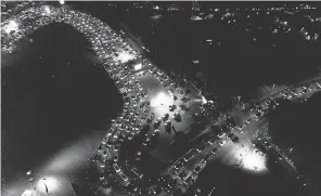  ?? RINGO H. W. CHIU/ AP ?? Motorists wait in long lines to get tested for the coronaviru­s in a parking lot at Dodger Stadium in Los Angeles.