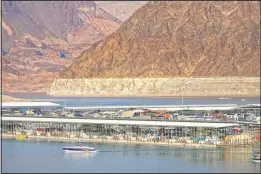  ?? (File Photo/AP/ John Locher) ?? A bathtub ring of light minerals delineates the high water mark in June 2020 on Lake Mead at the Lake Mead National Recreation Area near Boulder City.