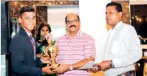 ??  ?? North Western Province Under-15 captain Chathumal Fernando receives cash award from NWPCA secretary Krishantha Kapuwatta and president Bimal Perera