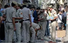  ?? — BUNNY SMITH ?? Police personnel and forensic officials inspect the site after a minor blast at Naya Bazar in Old Delhi area on Tuesday.